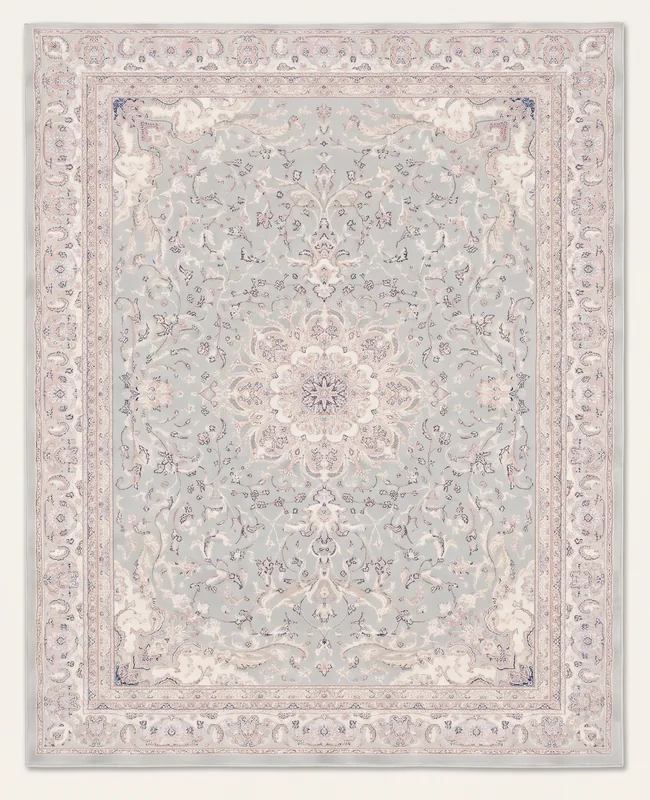 Muted rug with a faded central medallion motif and an ornate surrounding border.