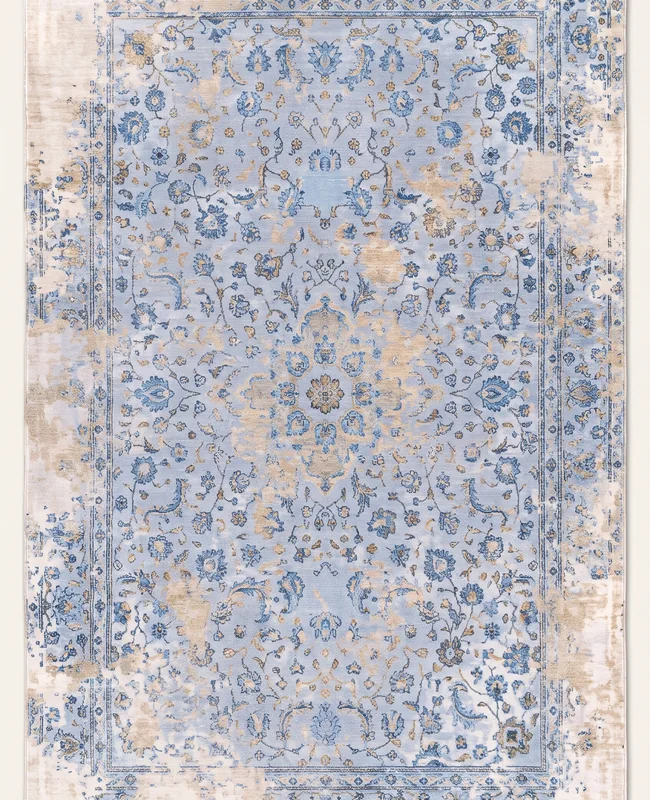 Light rug with a softly layered all-over pattern and a gently distressed surface.