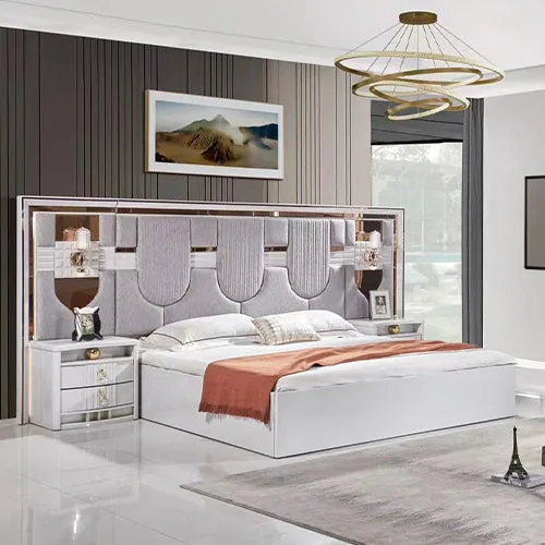 Modern upholstered bed with built-in bedside tables and a tall vertically panelled headboard.