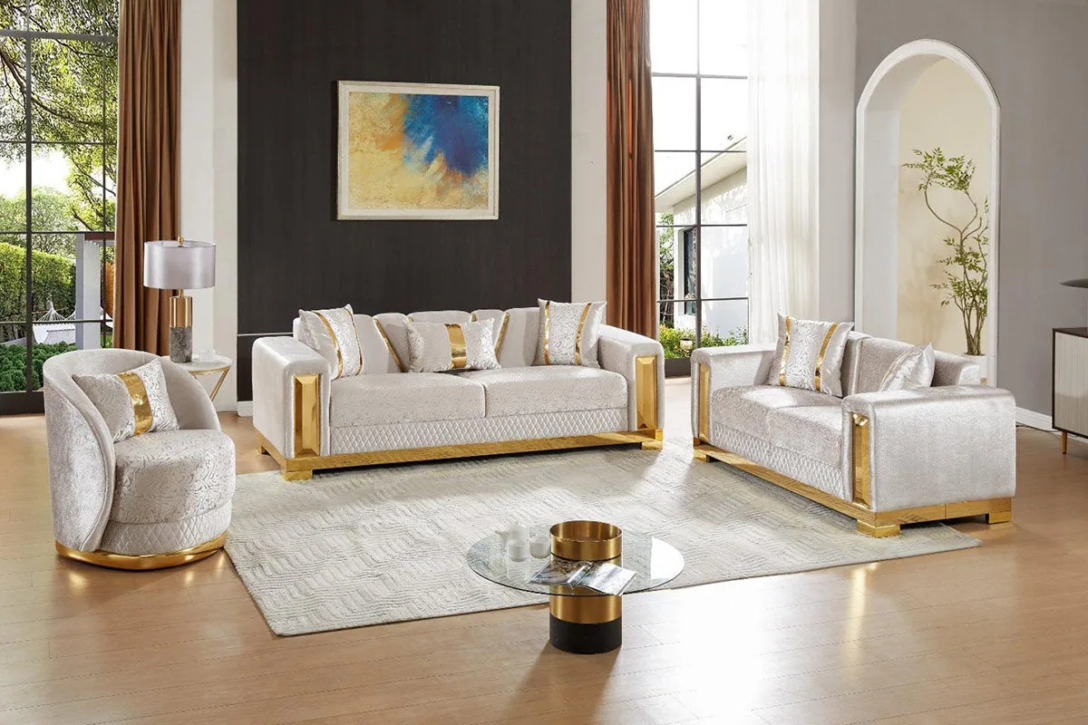 A quilted sofa set with a gold-accented frame and a polished raised base.