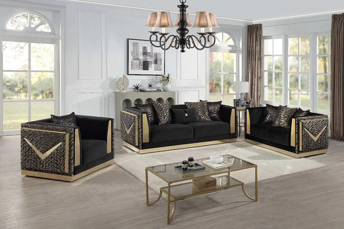 A black sofa set with gold detailing and patterned side panels on the arms.
