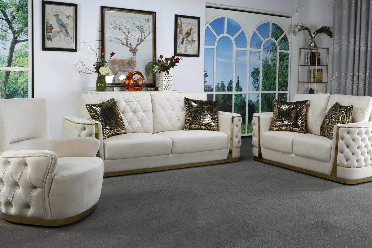 A button-tufted sofa set with padded arms and gold trim running along the base.