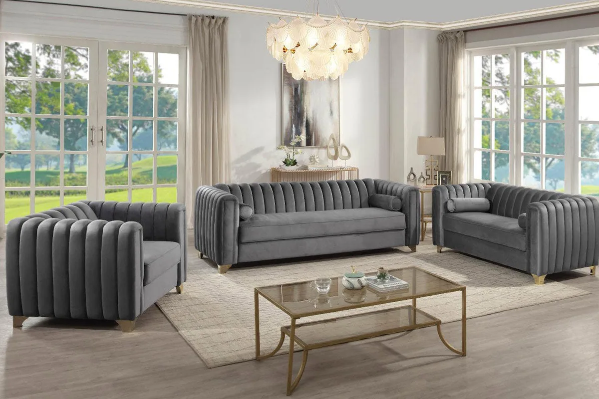 A grey sofa set with vertical channel-tufted backrests and rounded padded arms.